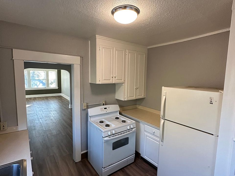 The kitchen features gas stove and other recent upgrades. View here is to the dining area and living room