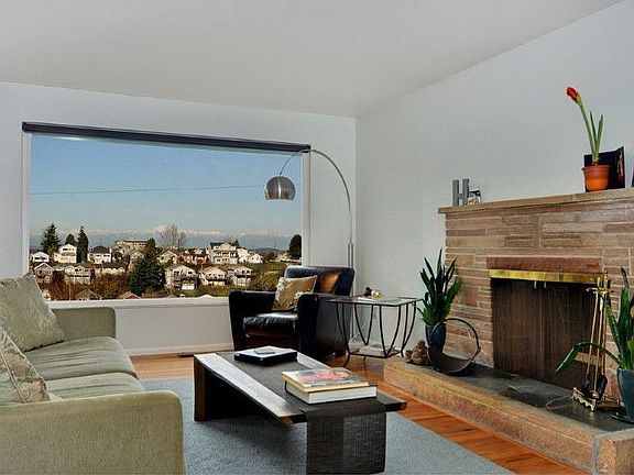 Bright and spacious main floor living area with roman brick fire place and newly refinished Oak, har