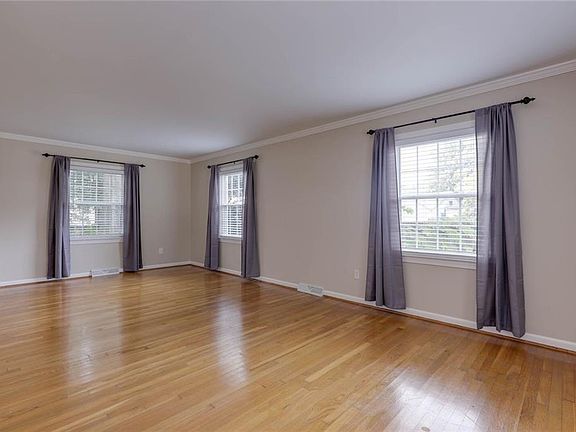 Living area with original hardwood flooring & abundance of natural light!