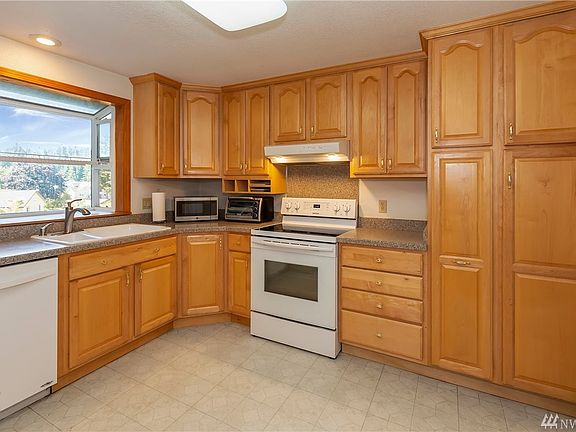 Kitchen with Garden Window, Plenty of Cupboards including a Pull Out Pantry and two Lazy Susans plus Room for A Dining Set!