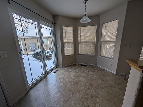Breakfast Nook Area in the Kitchen with Sliding Door Access to the Back of the Townhome