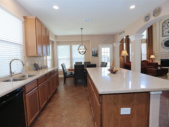 The kitchen! You'll love serving friends and family at this island, with room for bar stools. It's open to the living room, but separated by graceful arches and columns.