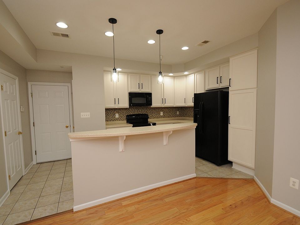 Kitchen with plenty of cabinet space and island with sink and dishwasher.