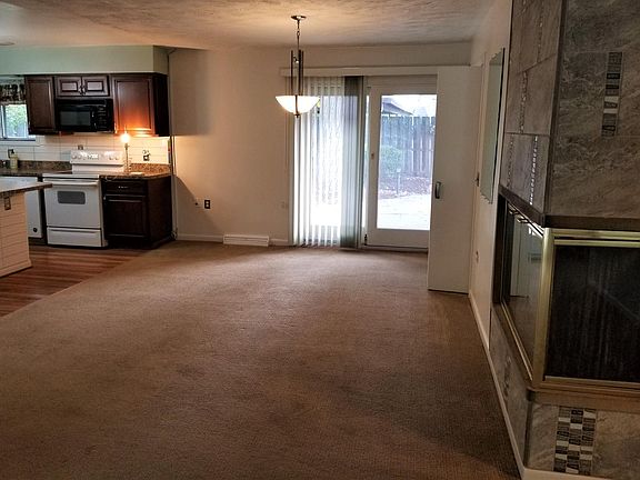View to dining area and south facing slider door to patio and back yard from front entryway.