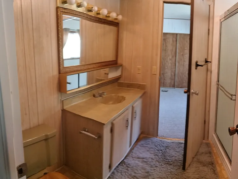 Guest bathroom with walkthrough to 2nd bedroom.