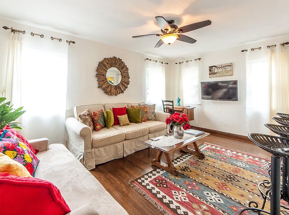 Larger sofa between windows is sofa/bed. Note TV has been re