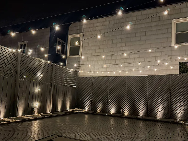 Lit backyard ready to host parties and events.