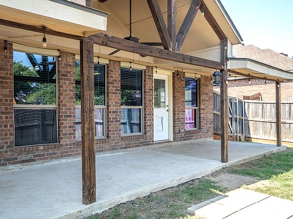 Large extended covered patio with power for a mounted TV and string lights.