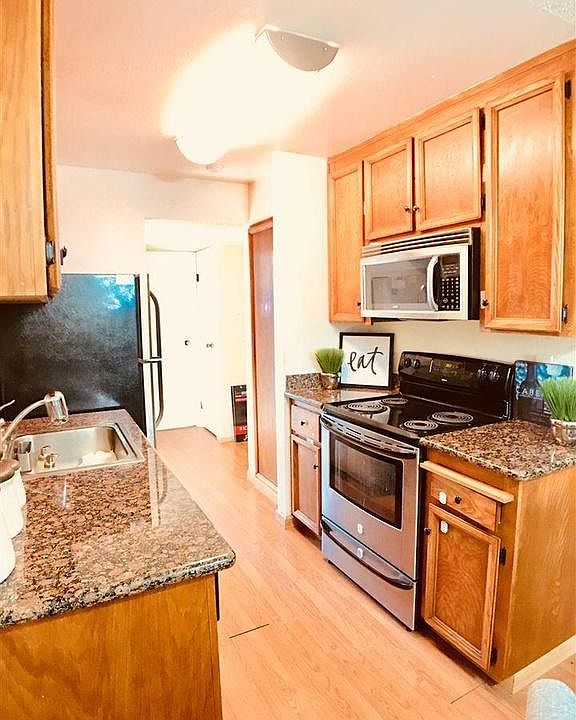 Very similar to kitchen in the unit being rented, kitchen floors are tile, not wood, cabinets are slightly lighter color, similar granite counter-top, appliances, and deep sink.