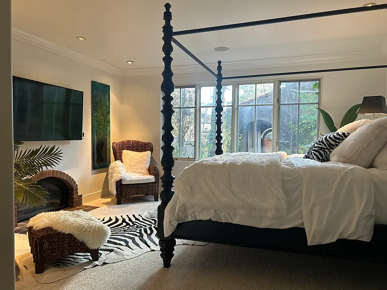 Master bedroom with gas fireplace and large screen TV
