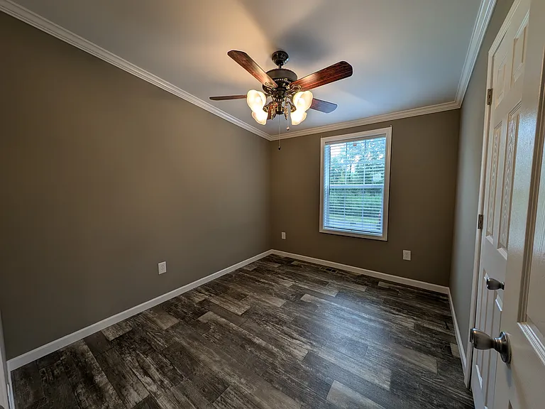 Bedroom 2 with window, ceiling fan, and lighted closet