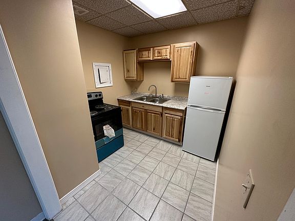 Kitchen with new stove, fridge, and tile floors!