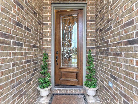 Check out the gorgeous front door and bricked front porch.
