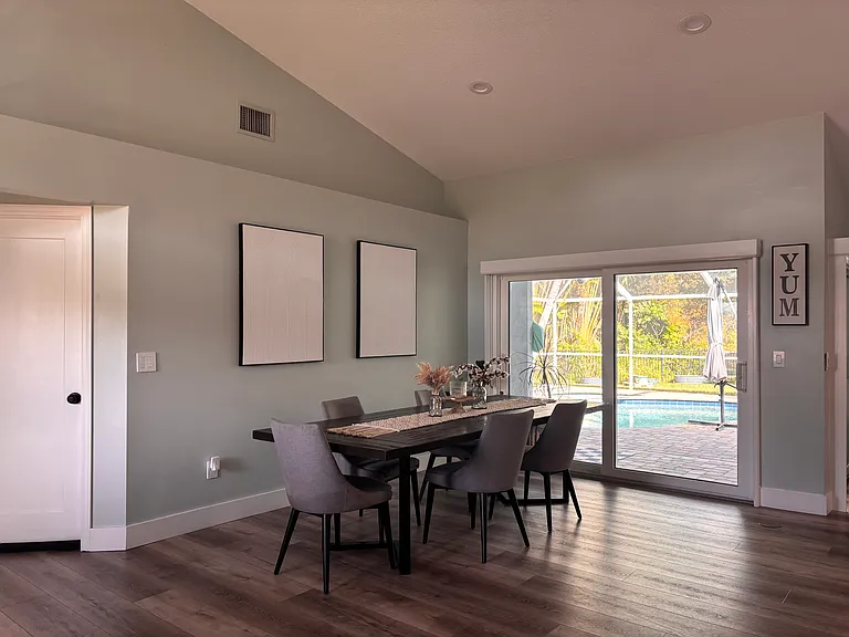 Beautiful view of patio and lake from dining table, sliding doors throughout