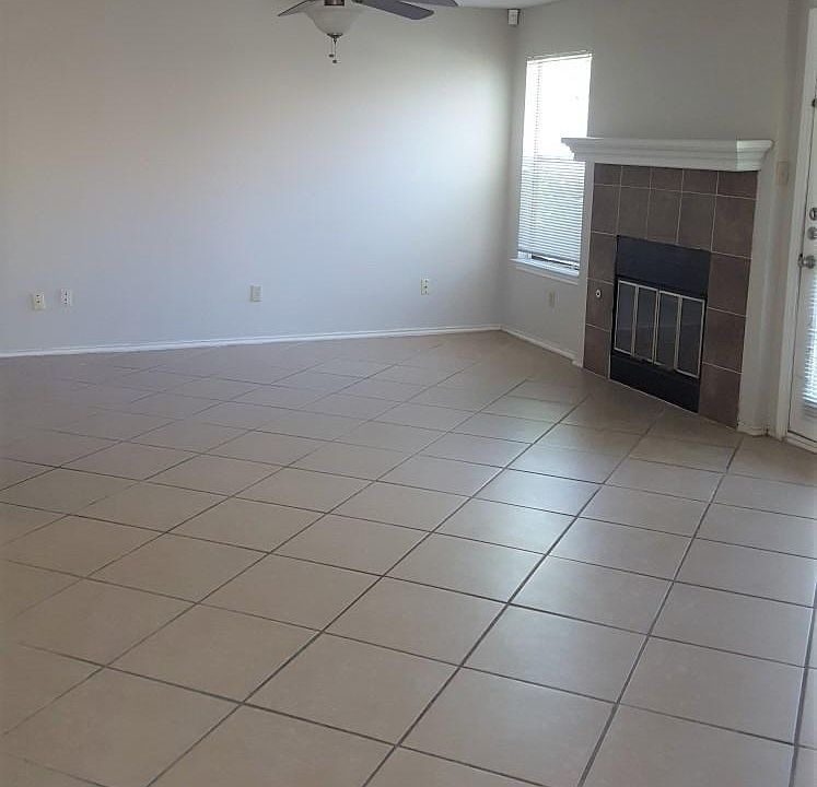 2nd living room in back of house with wood burning fireplace, door to back yard, open to dining area with window seat and kitchen