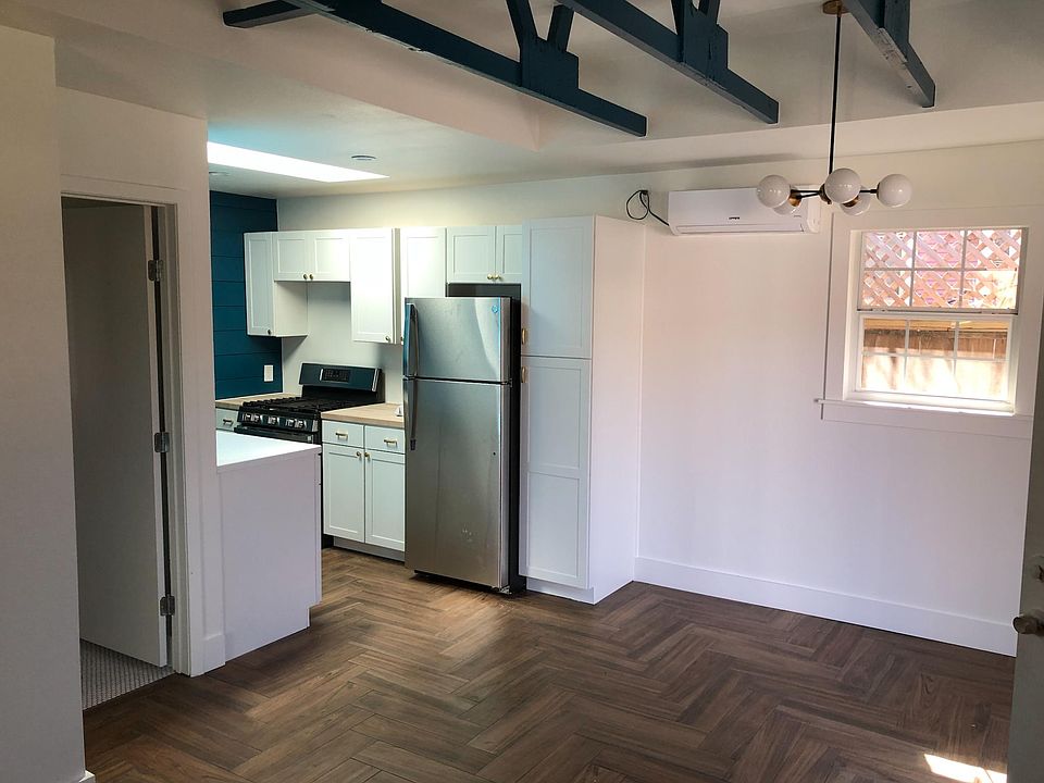 Enjoy the herringbone tile, open rafters, new kitchen, A/C, skylight, and clean, chic feel.