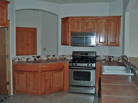 Stainless steel appliances and solid oak cabinetry