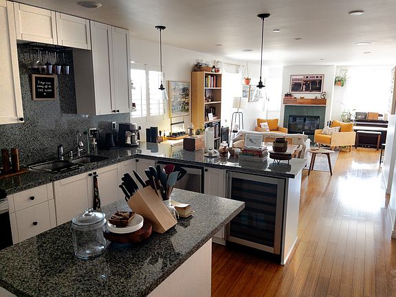 The kitchen has a large island and ample counter and cabinet space. The wine fridge is an extra touch.