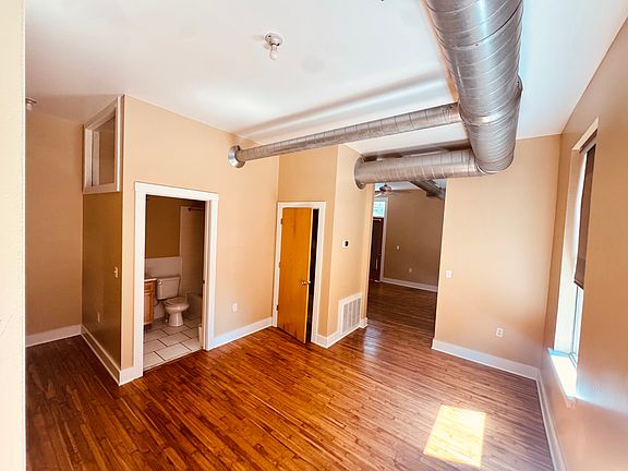 Sitting room before entering the primary bedroom. Bathroom is located in this area.