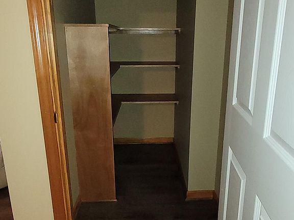 Down stairs - Standing in foyer facing east into storage closet under stair case