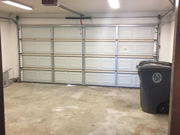 Two car garage; also has tool storage and shelves