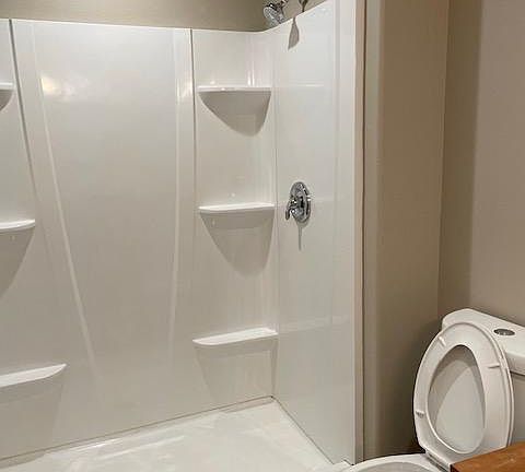 Master bedroom has private bathroom with walk-in shower. Glass doors are not shown in this photo, but are installed.