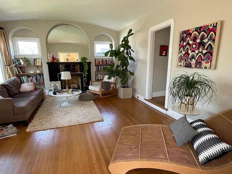 The sunny living room with high ceilings.