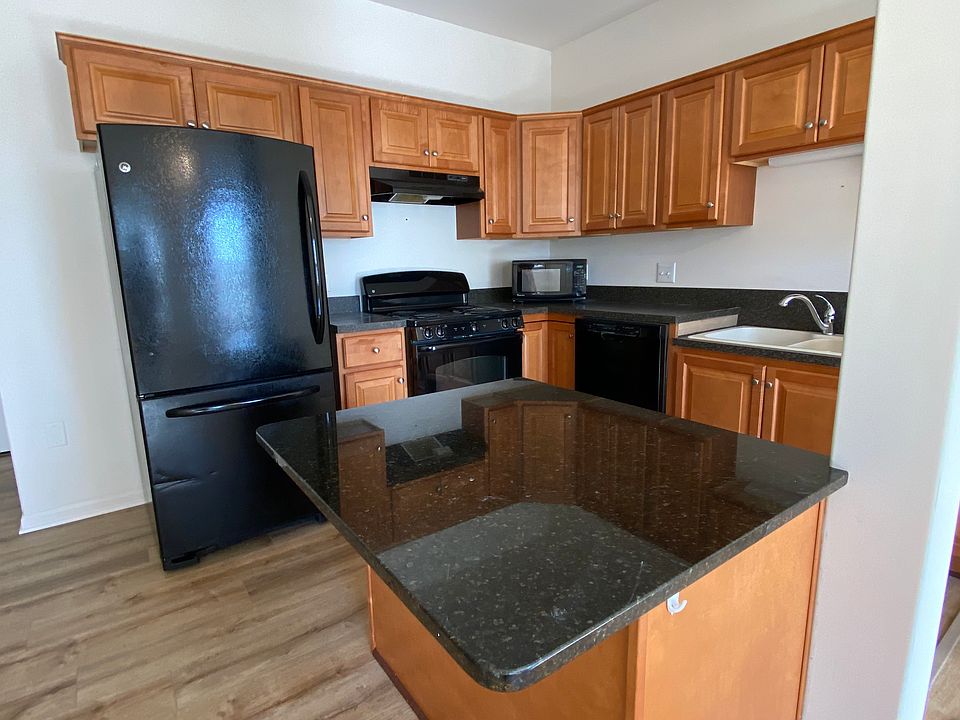 Open kitchen with lower countertop island and sink area to accommodate for roll-up access