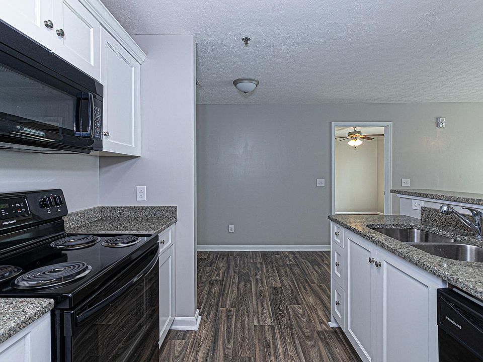 Ample Kitchen with Granite Countertops and Black Appliances