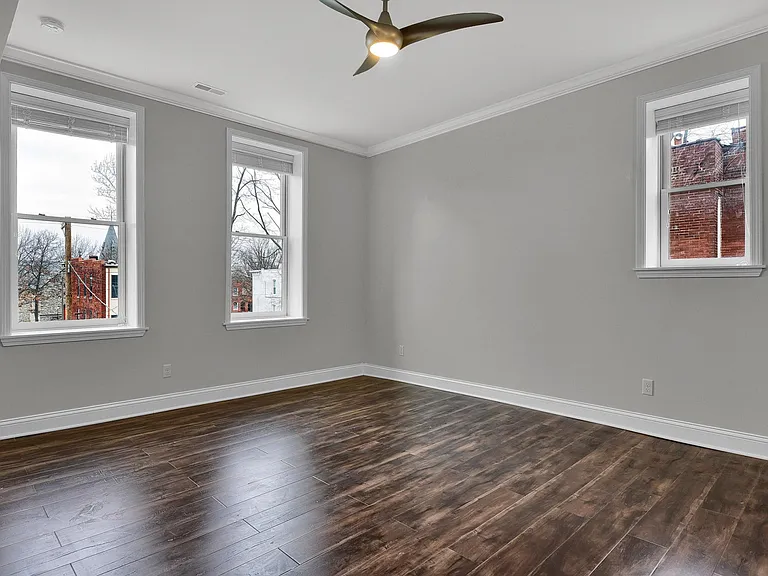 Family Room - level 1: Look at all the natural light! 10' ceiling, beautiful hardwood floors, elegant contemporary ceiling fan, venetian blinds, crown moulding