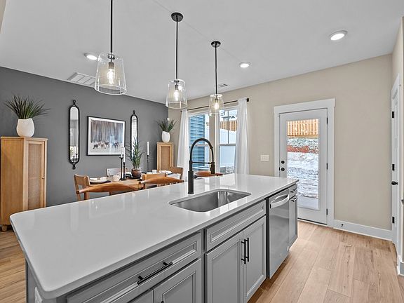 Exceptional culinary space with a striking 9-foot island and eye-catching pendant lights