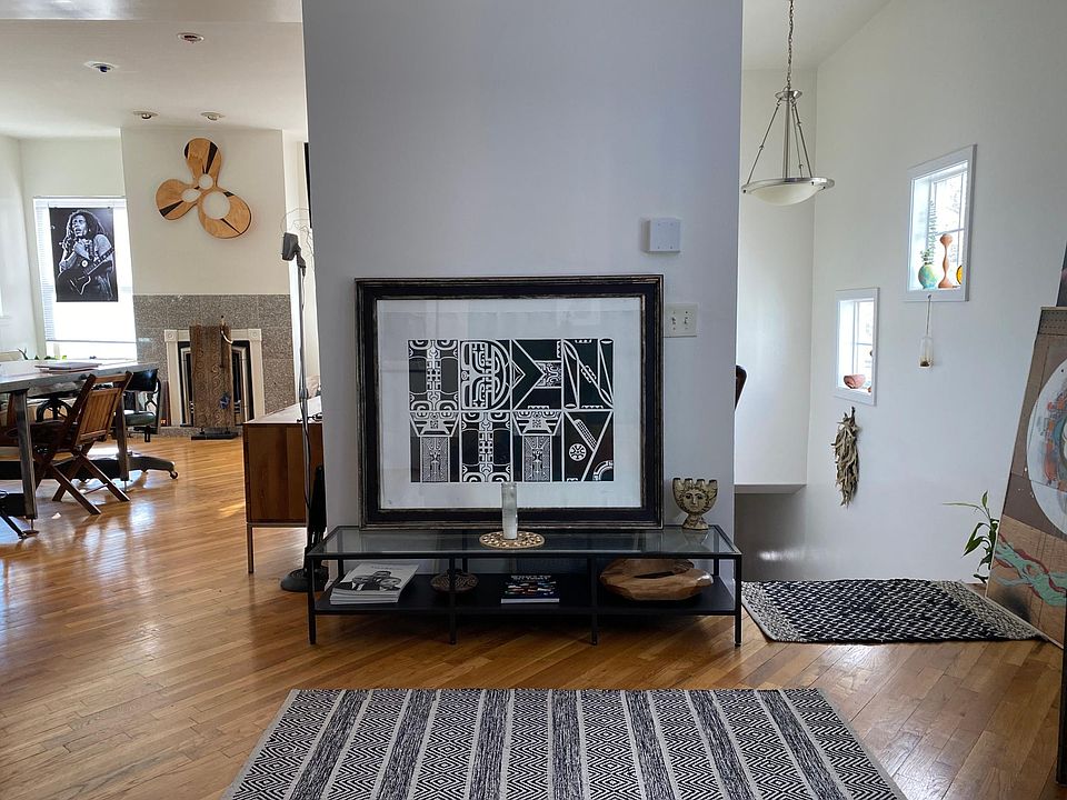 View from sitting on couch, stairs leading outside on your right and open kitchen area to your left