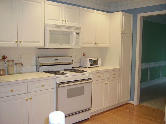 Kitchen with built in microwave and lots of cabinets and countertop space.