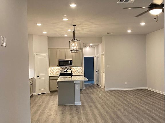Livingroom, kitchen looking into 2nd bedroom