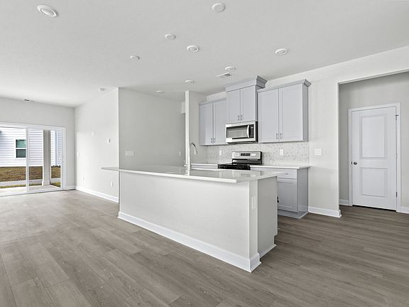 Enjoy preparing meals in this open kitchen with large work island.