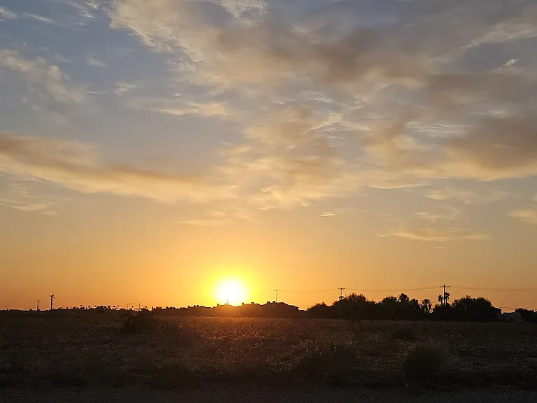Sunset behind property