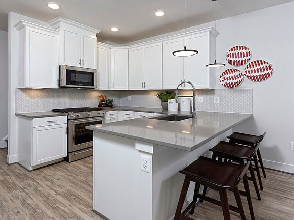 White Cabinetry in the Lawrence Gourmet Kitchen by Pulte Homes at Crown in Gaithersburg, MD.