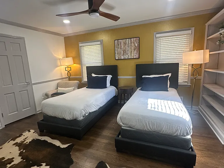 Spacious downstairs bedroom featuring twin beds, ideal for flexibility and comfort.