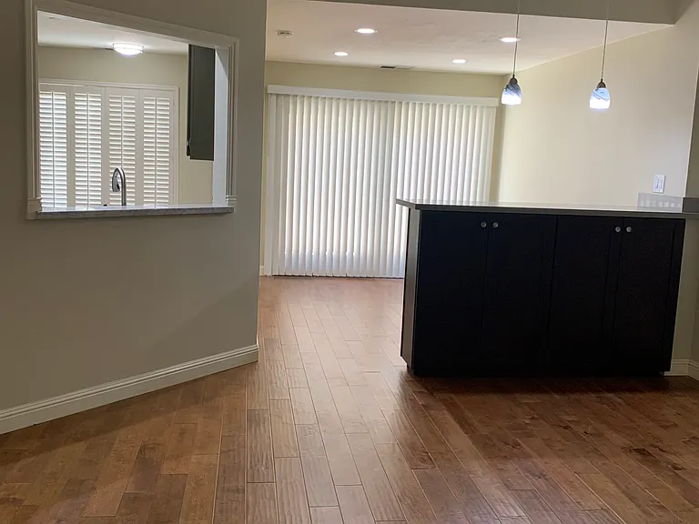 Living room with Dining room which opens to Patio/Deck and Kitchen