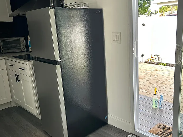 Fully equipped kitchen with drawers, sink, fridge, microwave, coffee maker and stove.