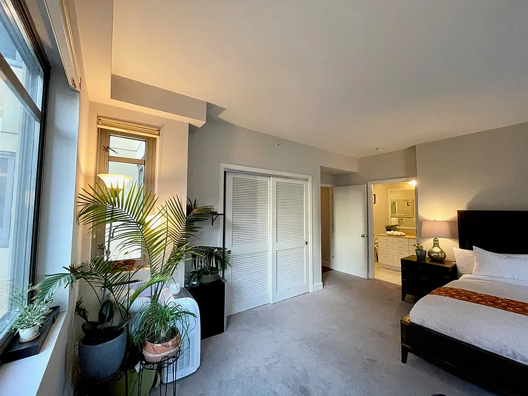 Oversized primary suite with natural light and room for a king bed.