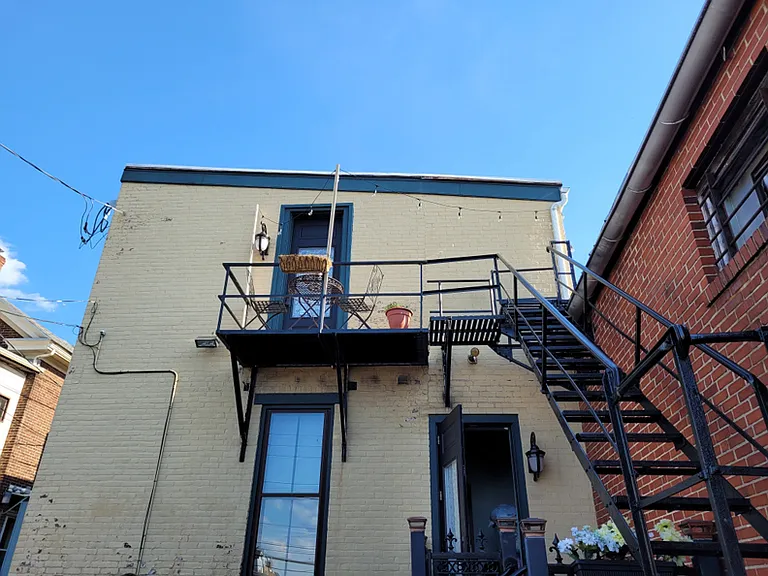 2ndFL REAR Kitchen door entry with fire escape, with metal deck, metal table and two chairs come with apt use