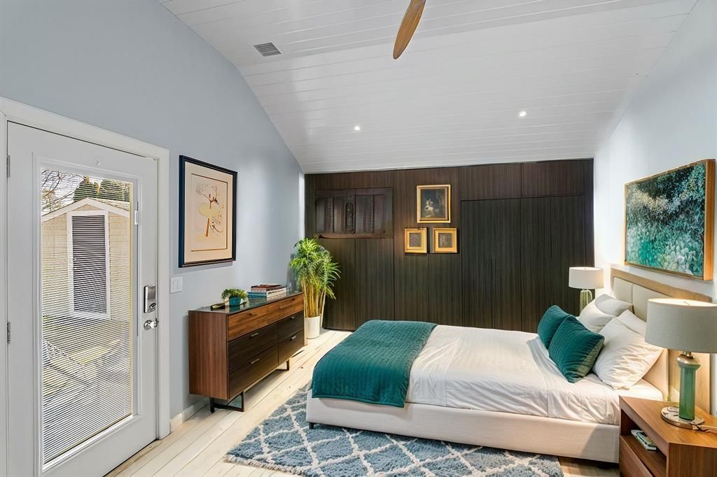  1 of 3 Beds featuring lofted ceiling, wooden walls, visible vents, and light wood-style floors- Easy