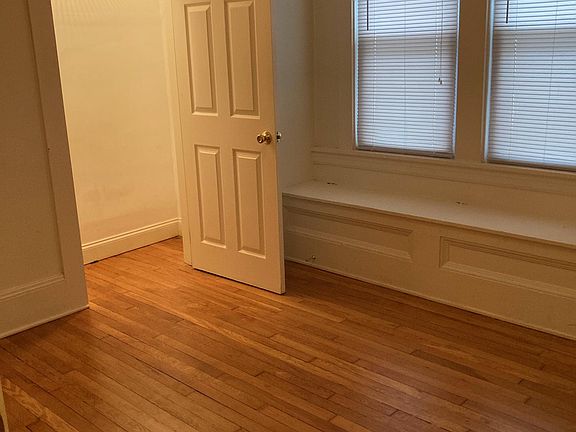 Bedroom with lighted closet and bench storage.