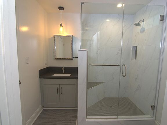 Bathroom with walk-in shower and bench