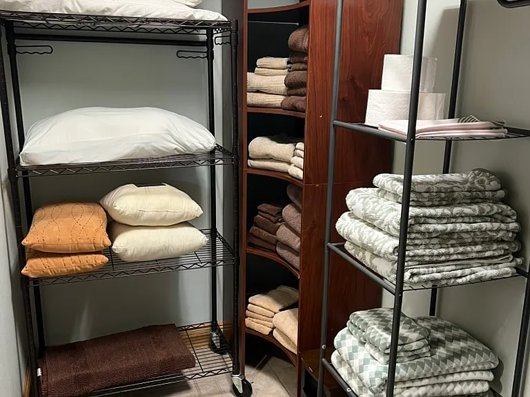 Huge walk-in closet! Lots of shelves for storage, clothes hamper. Extra pillows and tons of plush and oversized towels/hand towels and wash cloths.