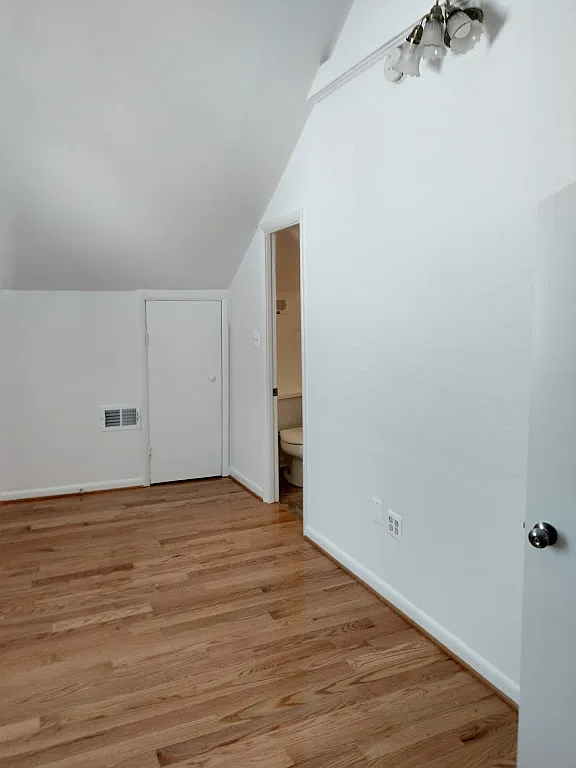 Bedroom with cathedral ceiling. Entrance to bathroom is to the right. - 2509 10th St NE #2