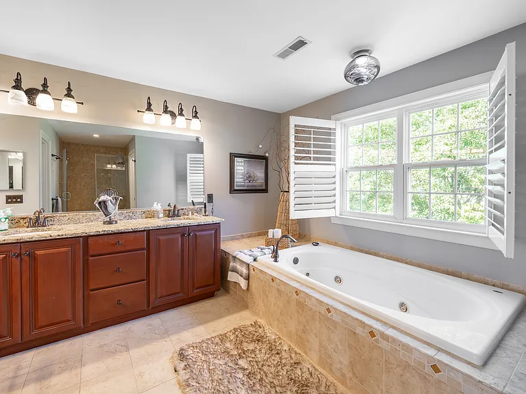 Master suite includes 2 walk in and 1 bonus closet. Large tube with jets and multi jet shower