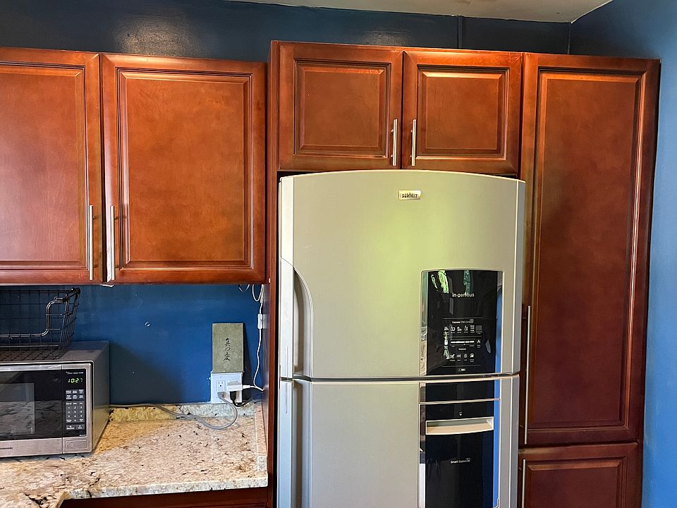Full kitchen with large refrigerator, dishwasher, microwave
