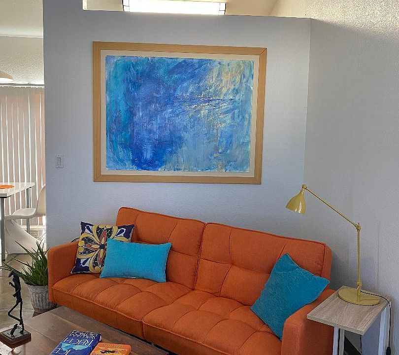 Stylish architectural features include vaulted ceilings. This photo shows living area opening into dining area.